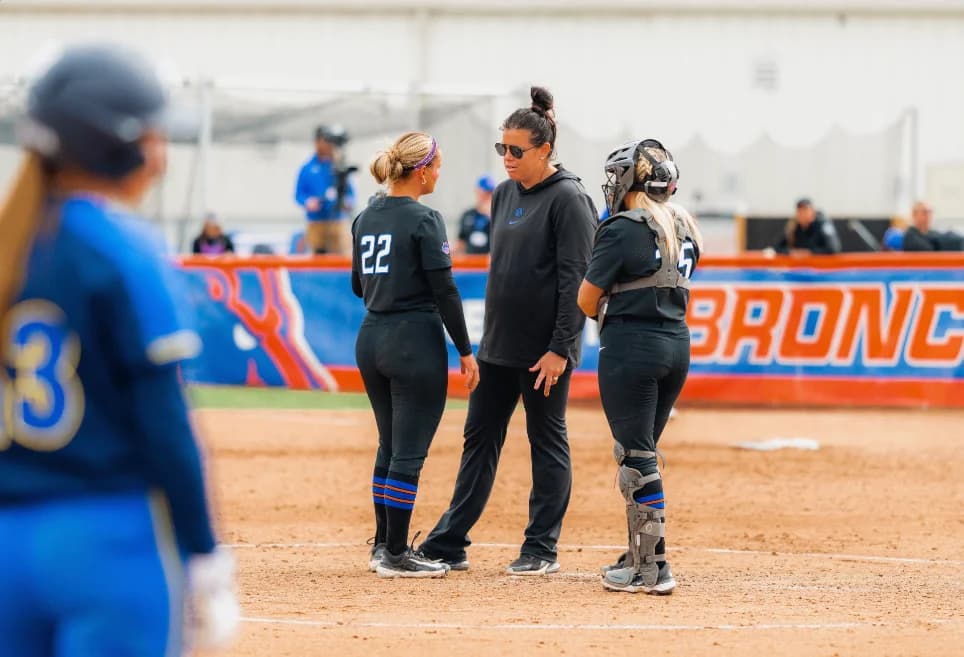 Coach Allie Walljasper talking with her pitcher and catcher